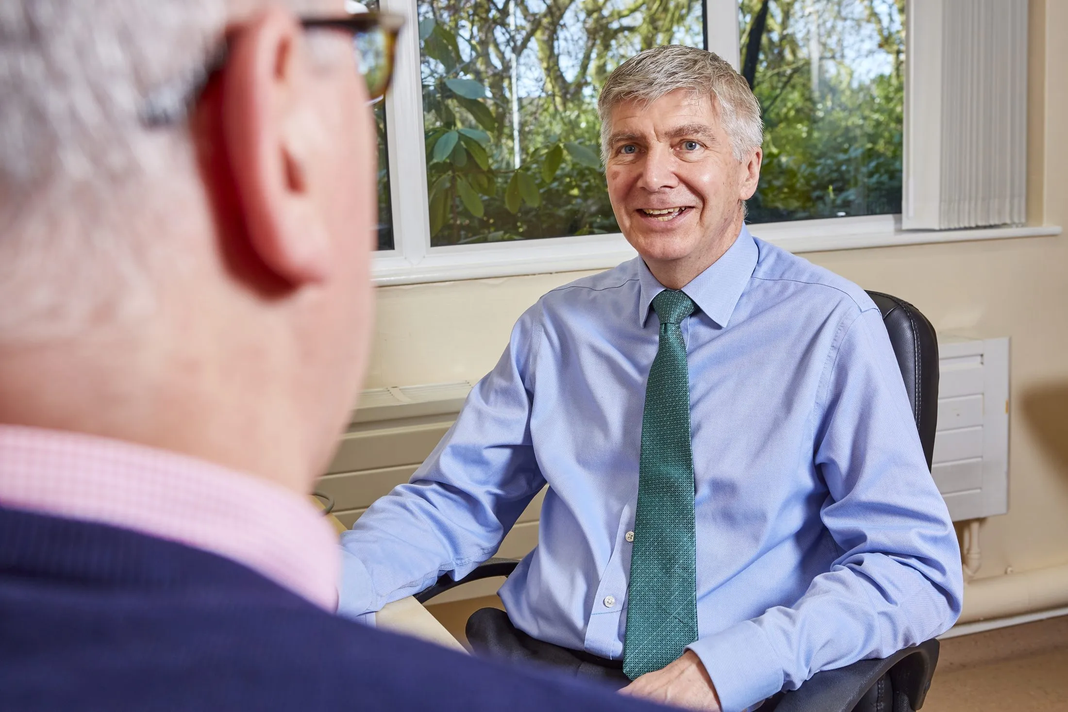 Dr Swan listening to a patient in consultation